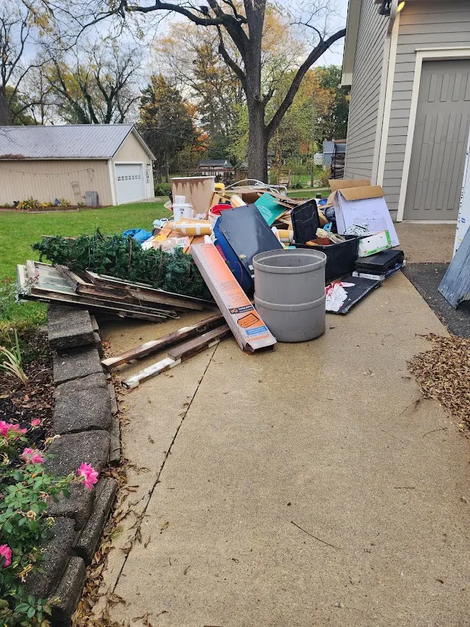 Dumpster being loaded with debris for Estate Cleanout Dumpster Rental in Pasco